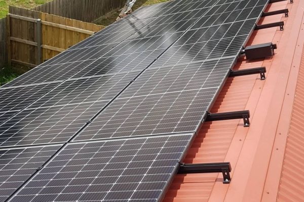 Solar panels installed on a terracotta roof by Quantum Electrical Services
